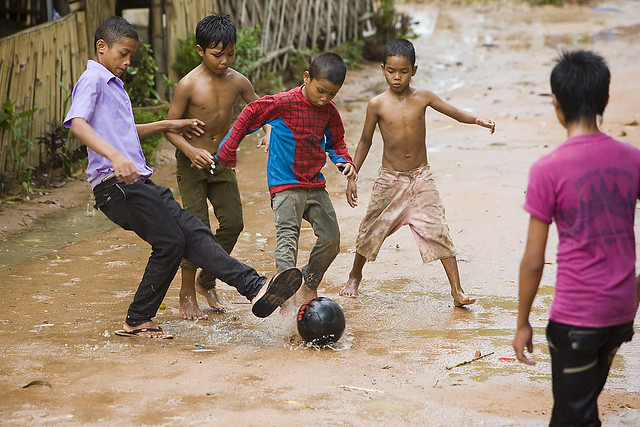 Children Playing Football In Rain