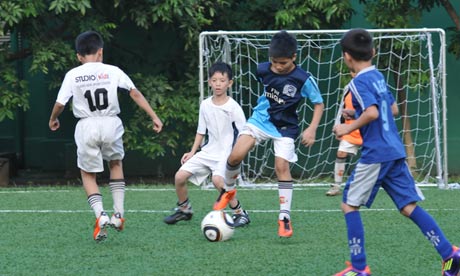 Children Playing Football In Rain