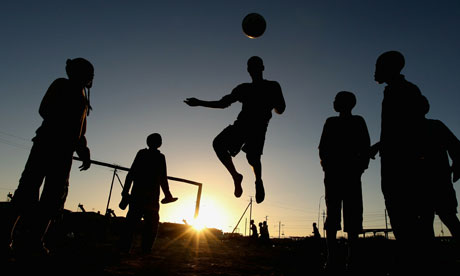 Children Playing Football In Rain